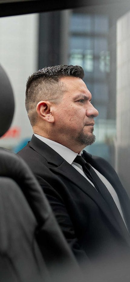 Private chauffeur Fabricio from Madrid waiting for passengers outside his vehicle.