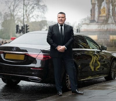 Private chauffeur Aldin from London outside his vehicle.