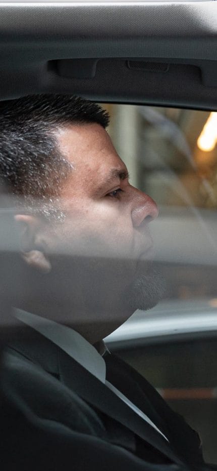 El chófer privado Jawir, de Nueva York, espera dentro de su vehículo.