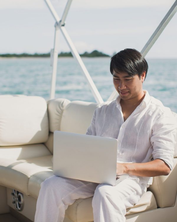 Man working on a yacht booking a chauffeur service