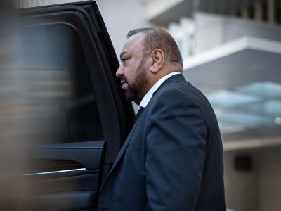Private chauffeur Atif from Washington, D.C. opening the door of his vehicle.