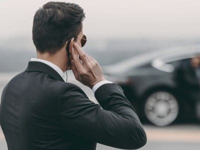 handsome bodyguard standing and listening message with security earpiece on helipad