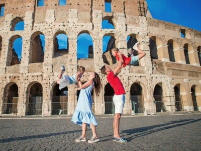 Happy family in Rome over Coliseum background