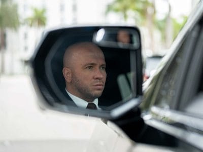 Private chauffeur Stevan from Miami seen in the side mirror of his vehicle.