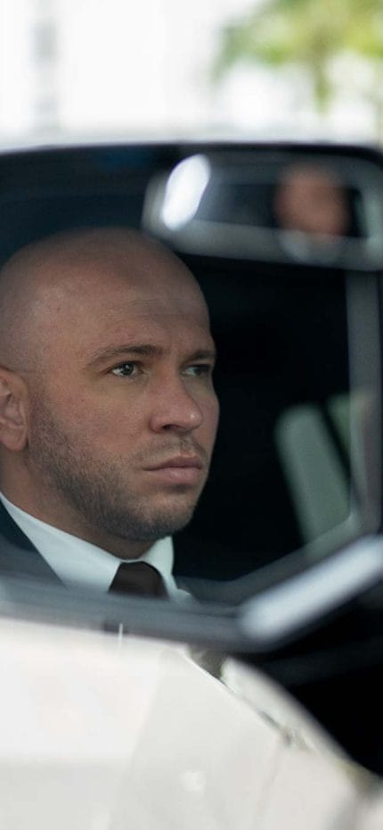 Private chauffeur Stevan from Miami seen in the side mirror of his vehicle.