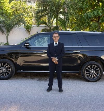 Private chauffeur Jose Ezequiel from Cancun outside his vehicle waiting for a passenger