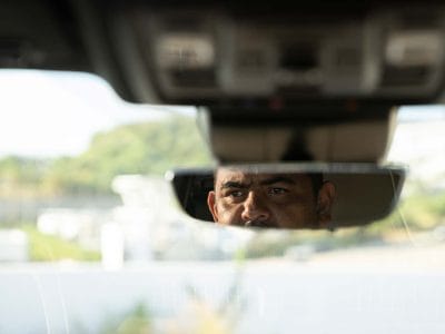 Private chauffeur Jesus from Los Cabos reflected in the mirror of his car