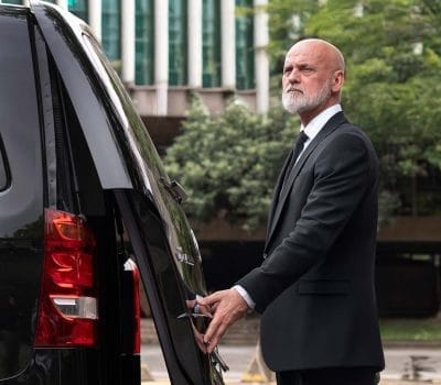 Private chauffeur Robson from Sao Paulo outside his vehicle at work
