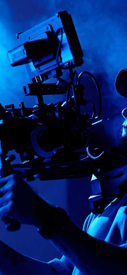 Cameraman holding his camera, working.