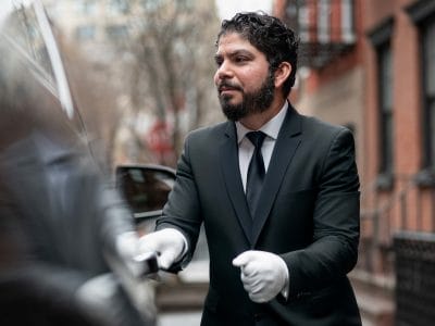 O motorista particular Ronald, de Nova York, do lado de fora de seu veículo.