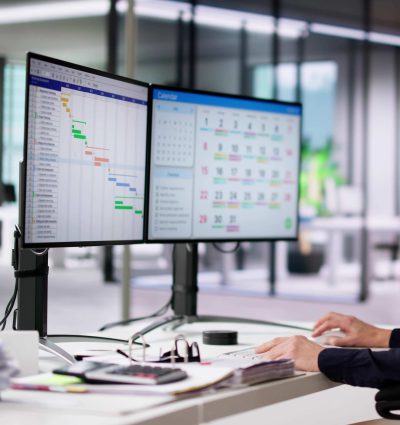 Employee Working On Calendar Schedule And Staff Time Sheet