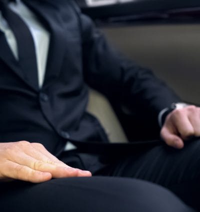 Unkown corporate traveler inside a corporate vehicle.