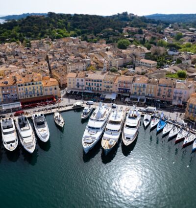 Aerial view of Saint Tropez with mega yachts and sailboats preparing for the races on Regatta Day